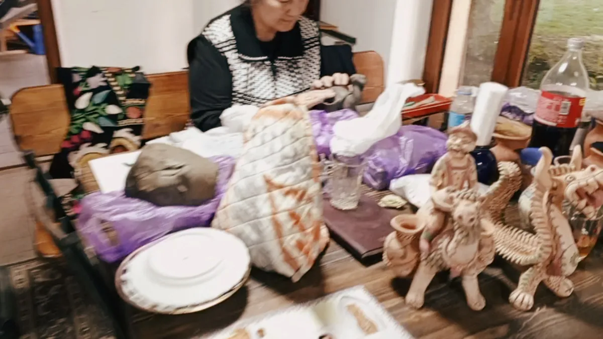 Hand-made Uzbek ceramic figurines and plates on a craft table in Samarkand